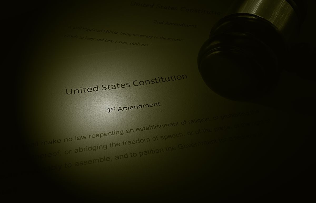 US Constitution text showing the first amendment, with legal gavel                               
